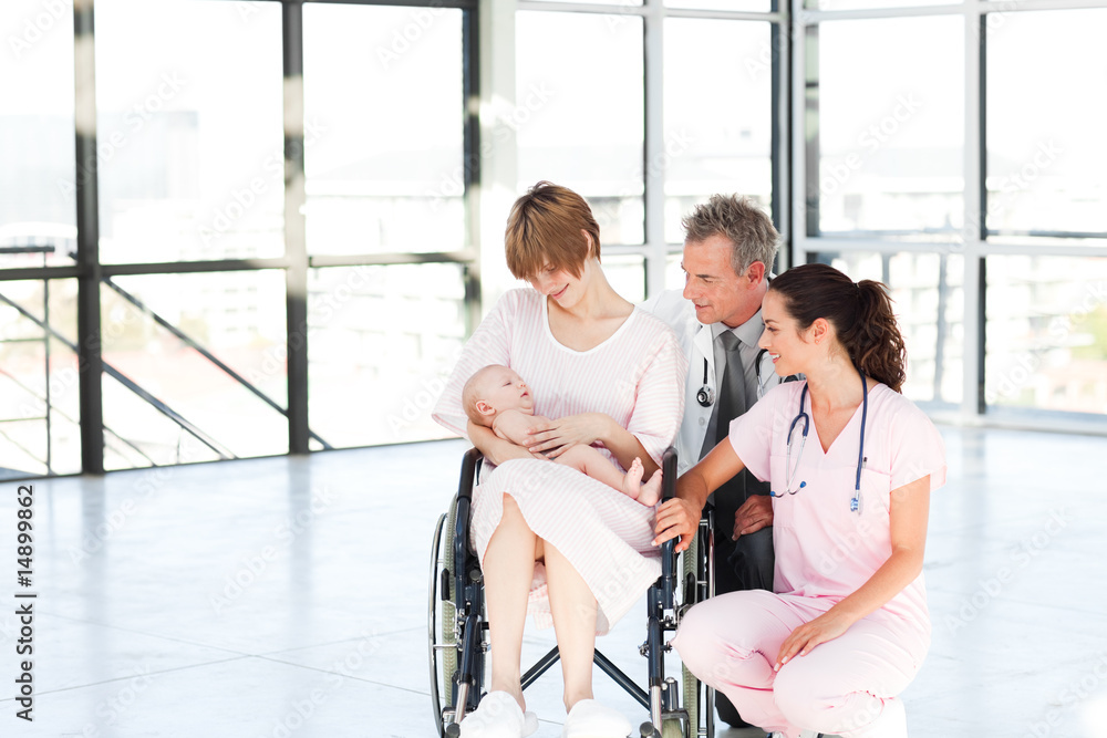 Mother with her newborn baby and doctors with copy-space Mother with her newborn baby and doctors with copy-space