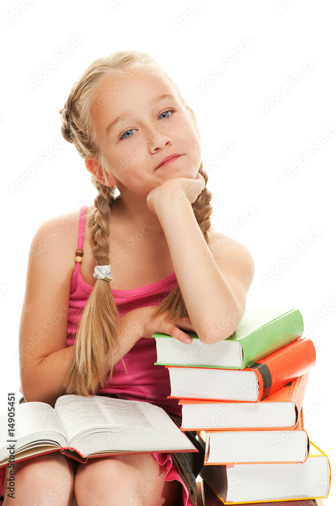 Thoughtful little schoolgirl sitting on a stack of books Thoughtful little schoolgirl sitting on a stack of books