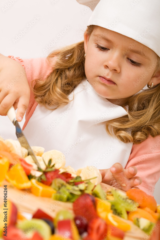 Little girl chef with lots of fruits Little girl chef with lots of fruits