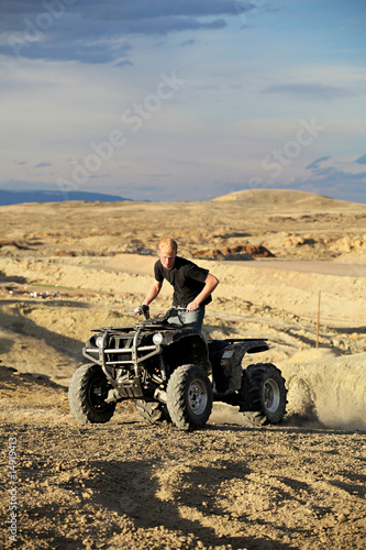 quad in hills - teen on four wheeler ATV