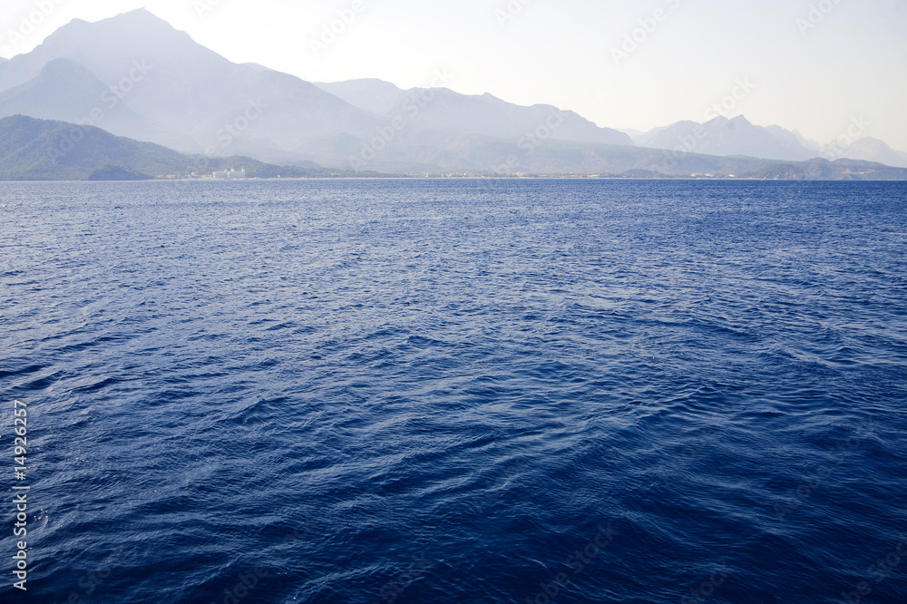 blue waves of Mediterranean on a background mountains