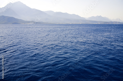 blue waves of Mediterranean on a background mountains