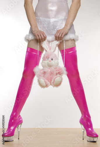 extravagant pink boots and hand holding a rabbit toy