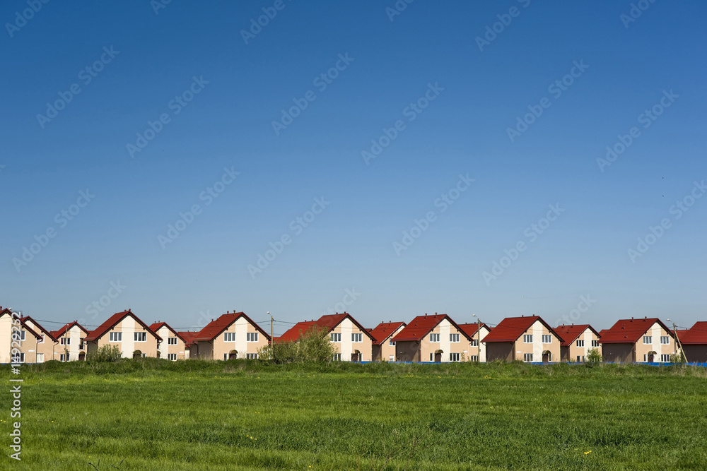 Vászonkép New cottages and blue sky
