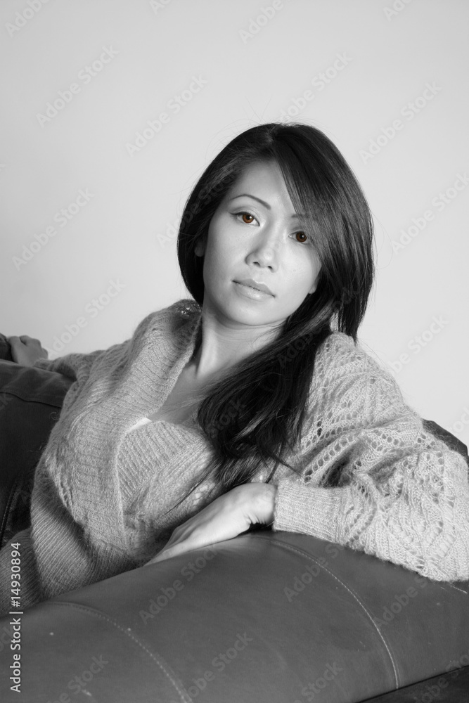 Pretty asian american woman resting on a couch Pretty asian american woman resting on a couch