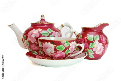 Porcelain tea service with floral pattern isolated photo