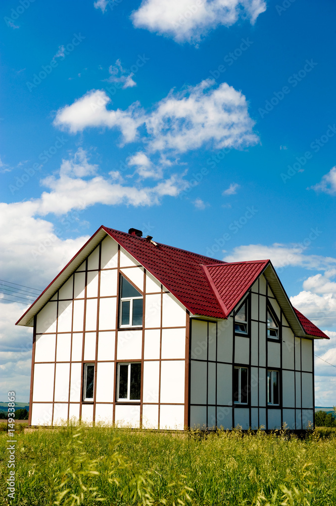 Brand new home for sale with bright sky background