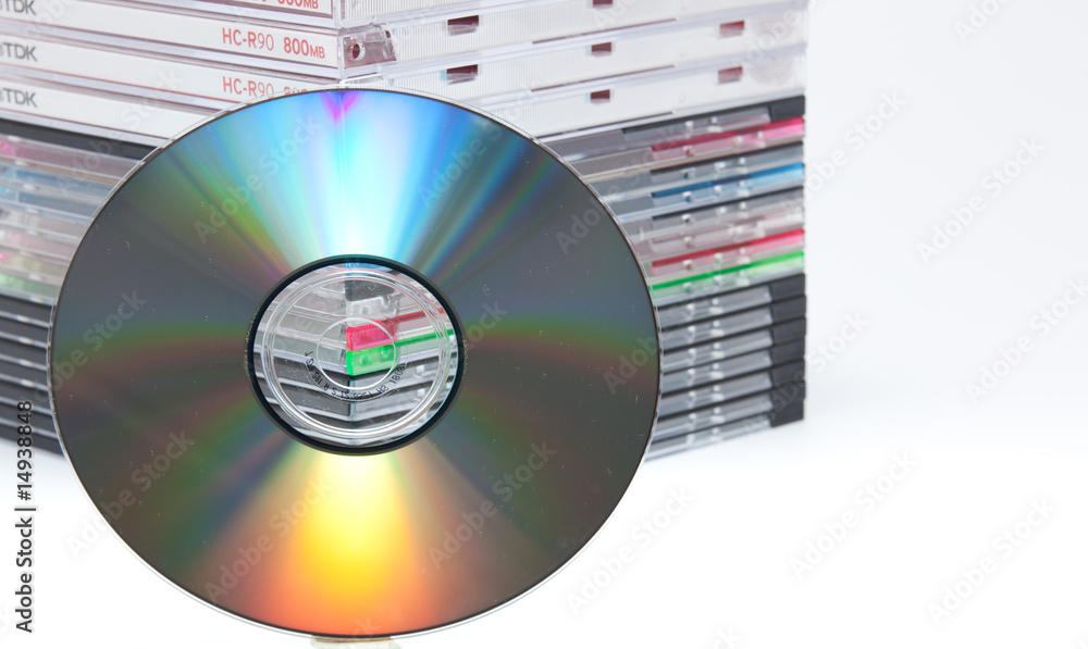 a blank dvd or cd with stack of empty cd cases on background Stock Photo |  Adobe Stock