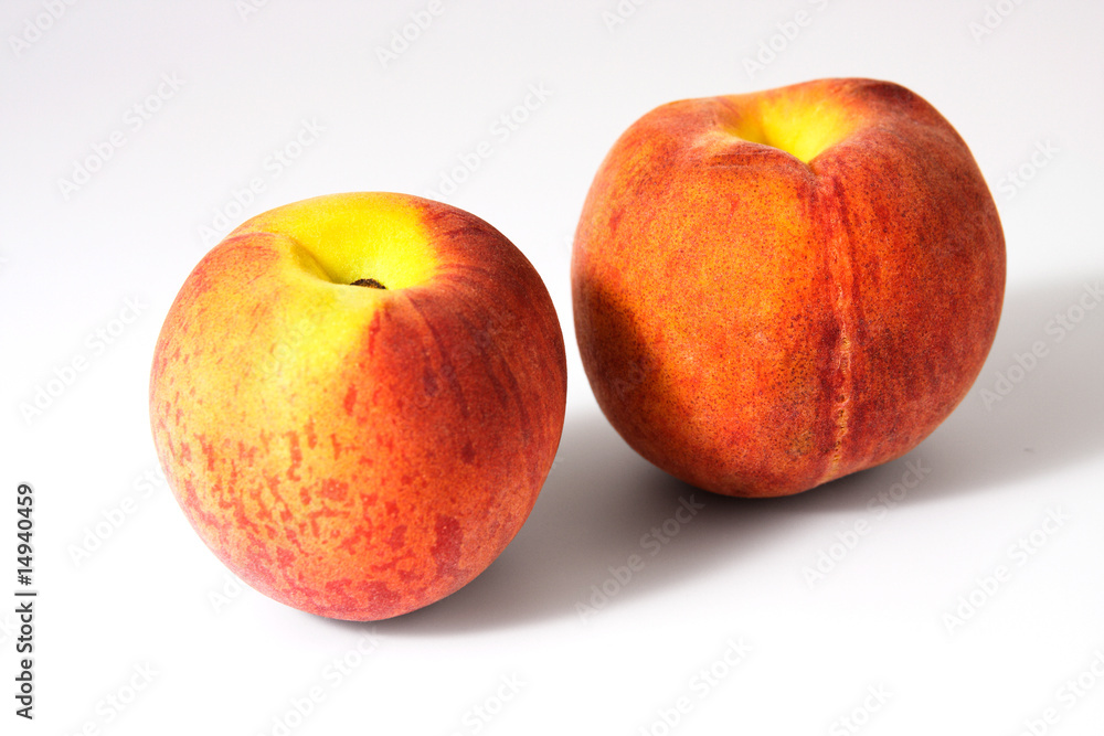 Two tasty juicy peaches on a white background Two tasty juicy peaches on a white background