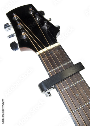 guitar neck fitted with capo on white background photo