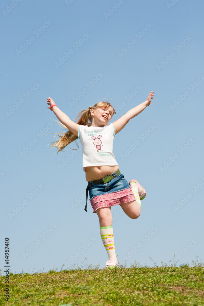 Little girl jumping against beautiful sky Little girl jumping against beautiful sky