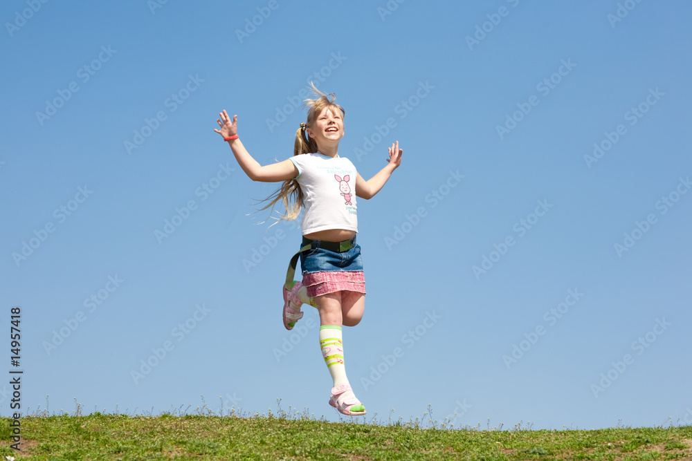 Little girl jumping against beautiful sky Little girl jumping against beautiful sky