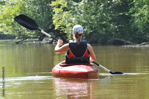 Young Woman Kayaking on the River