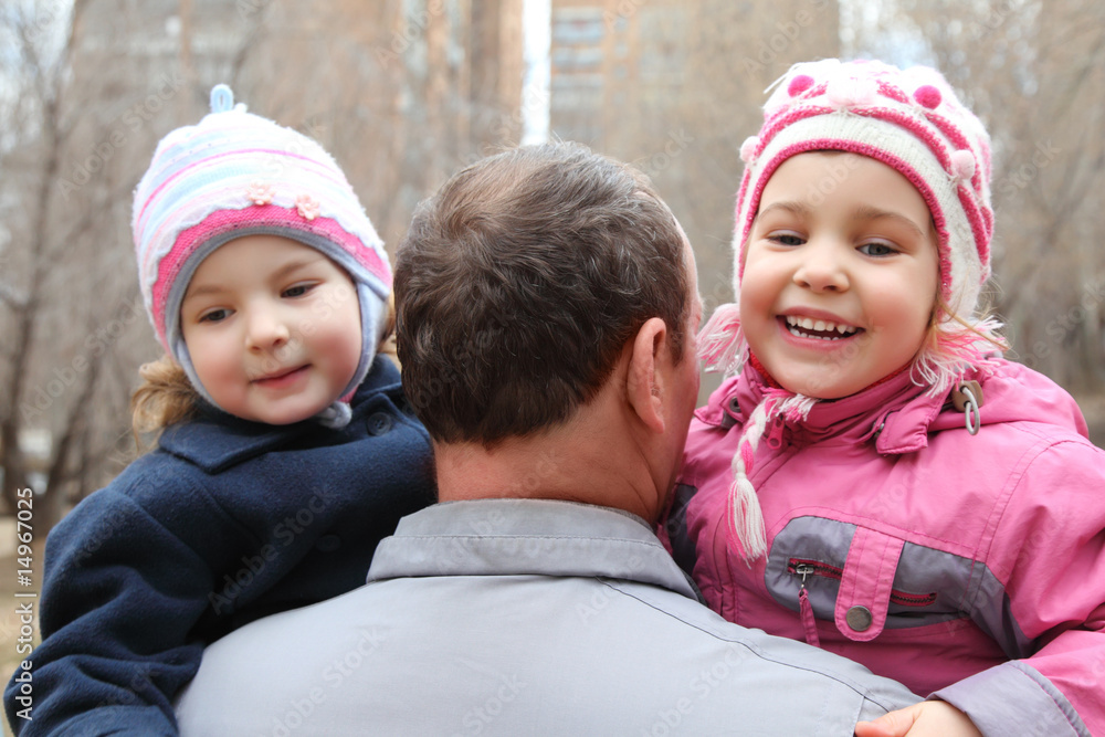 elderly man with two children on hands from back elderly man with two children on hands from back