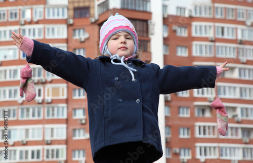 little girl with divorced hands against background building photo