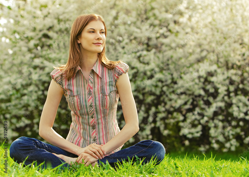 Beautiful young woman meditating outdoors Beautiful young woman meditating outdoors
