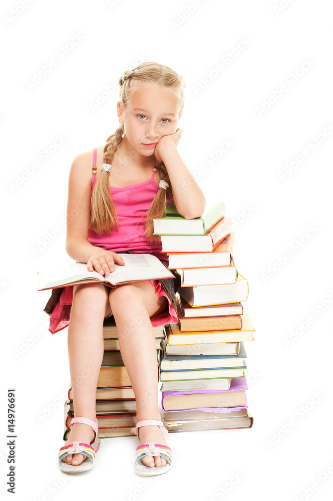 Little schoolgirl sitting on a stack of books.... Little schoolgirl sitting on a stack of books....
