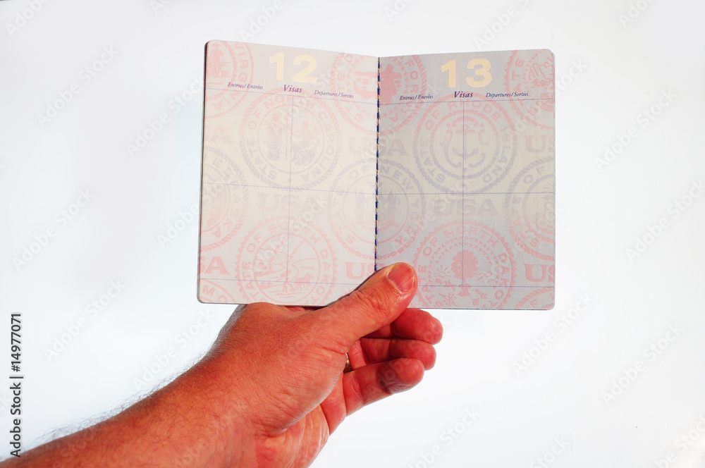 Hand holding open passport Hand holding open passport