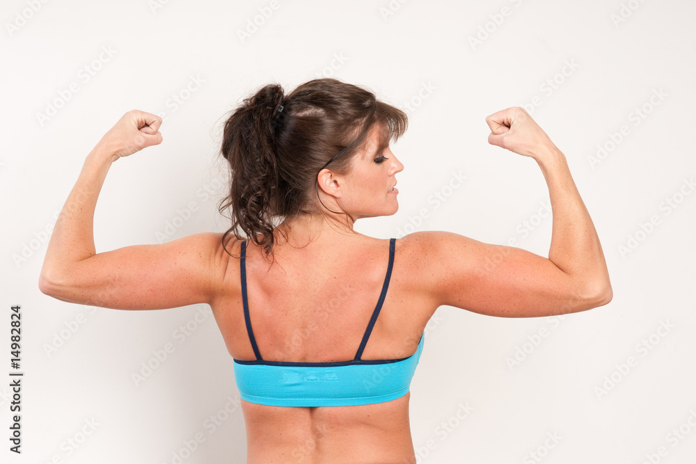 Woman Flexing Her Muscles From Back Stock Photo, Picture and