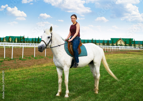 smiling young girl astride a horse © vikiri