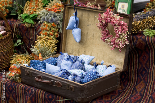 Dried wild flowers and handmade decor in old fashioned suitcase