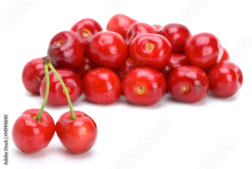 Pile of red ripe cherries and two stand-alone