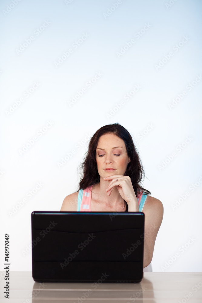 Serious woman working with her laptop with copy-space Serious woman working with her laptop with copy-space
