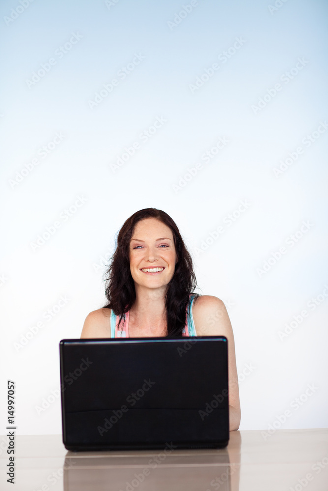 Smiling girl using a laptop with copy-space Smiling girl using a laptop with copy-space