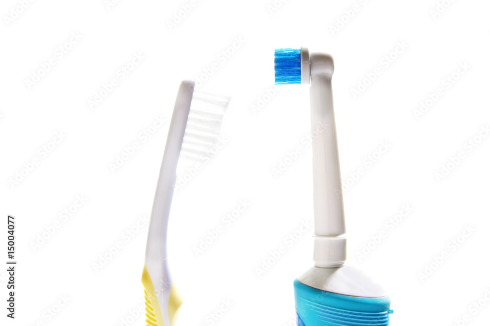 regular and electric tooth brushes on white background regular and electric tooth brushes on white background