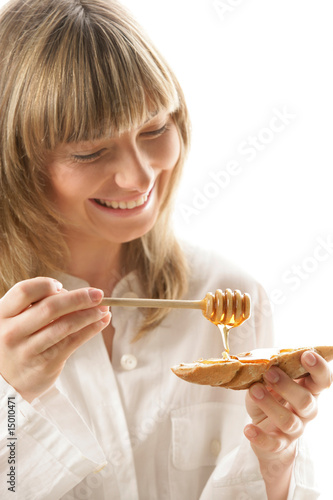 Young woman with honey and bread