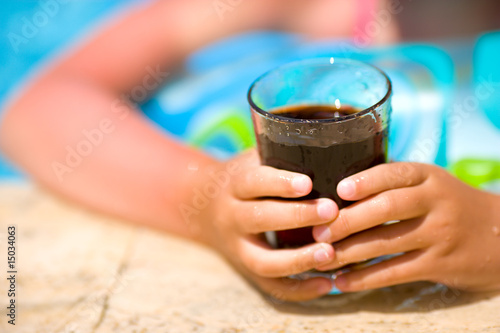Child holding cola drink