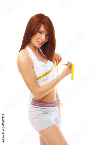 Smiling fit woman with measure tape.