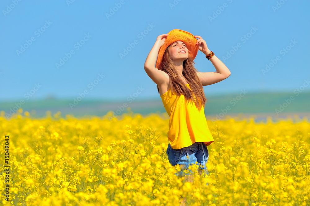young woman on rape field in bloom young woman on rape field in bloom