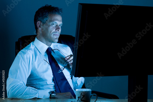 Businessman working till late photo