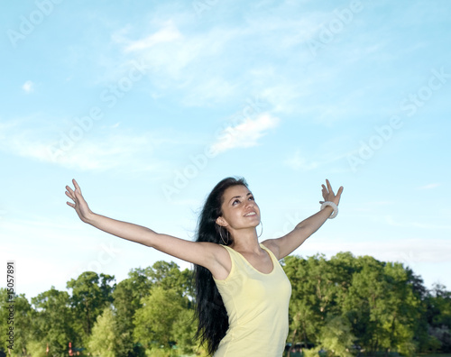 girl spreading her arms in the view of the sky