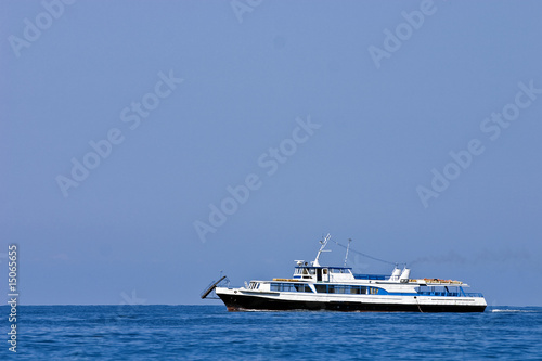 ship on a background of blue waves of ocean and the sky