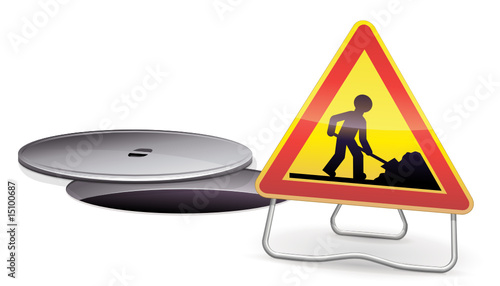 Bouche d'égout ouverte et son panneau de signalisation travaux