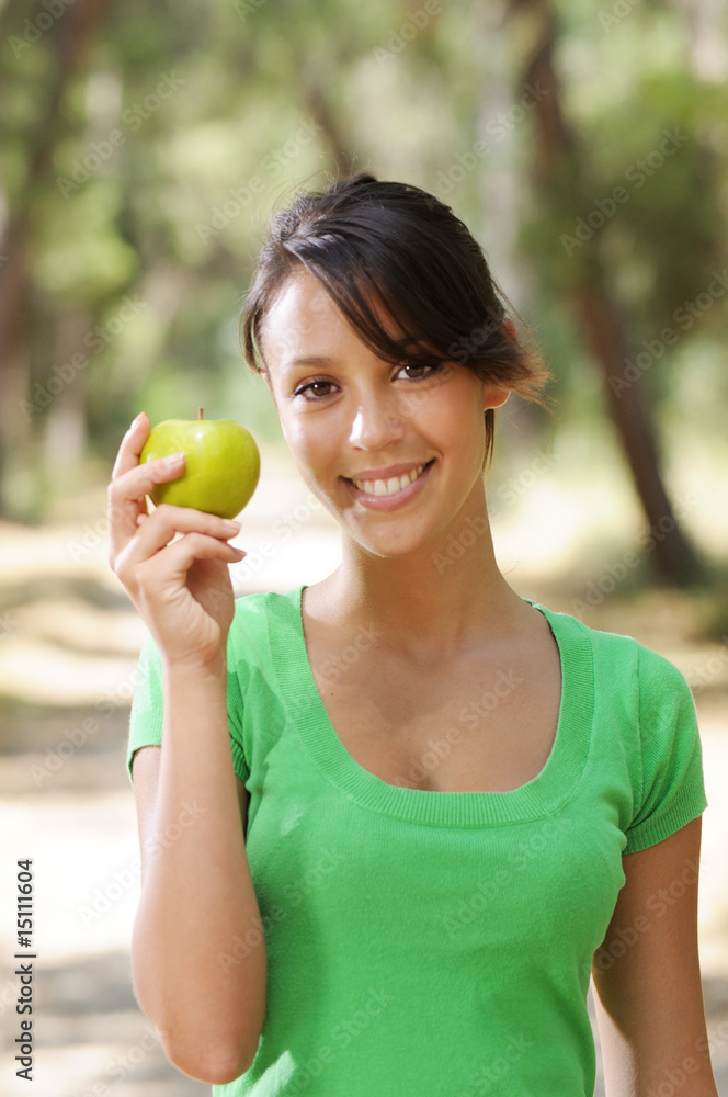 young woman with green apple, smiling and looking in camera young woman with green apple, smiling and looking in camera