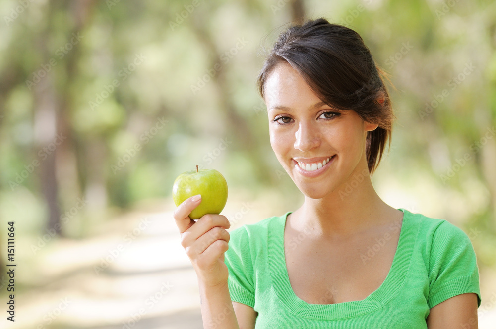young woman with green apple, smiling and looking in camera young woman with green apple, smiling and looking in camera