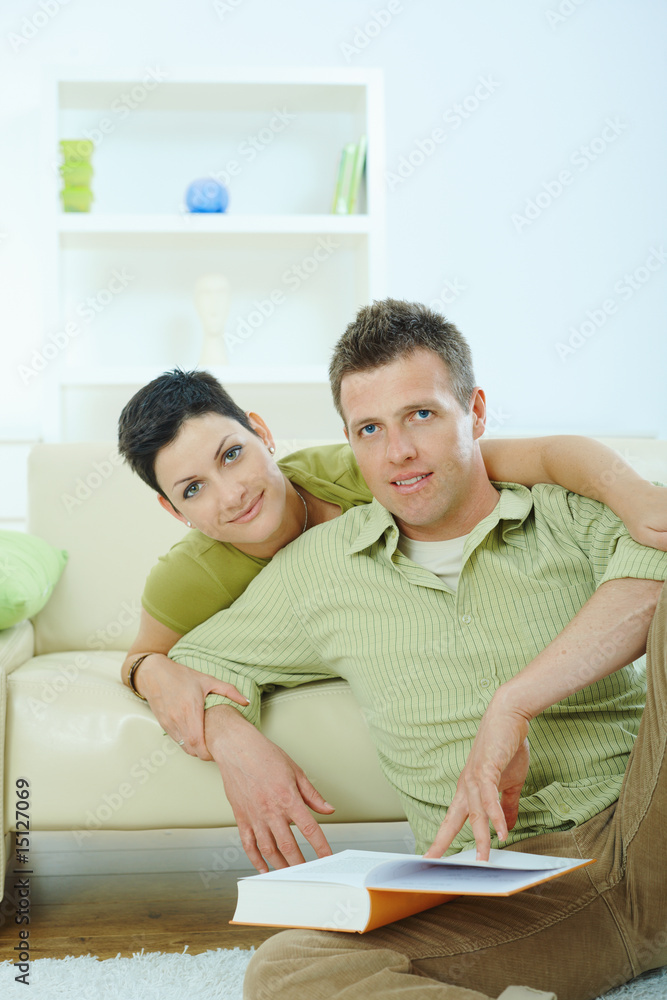 Couple reading book at home Couple reading book at home