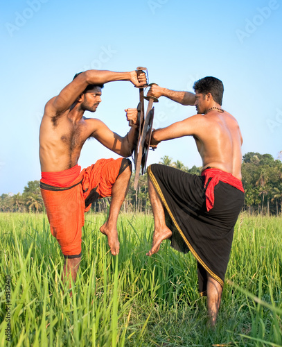 Kalarippayat,two warriors with swords and shields photo