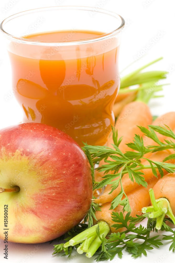 glass of fresh juice, some carrots and apples glass of fresh juice, some carrots and apples