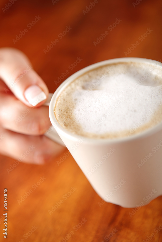 girl keeping a cup of coffee with milk girl keeping a cup of coffee with milk