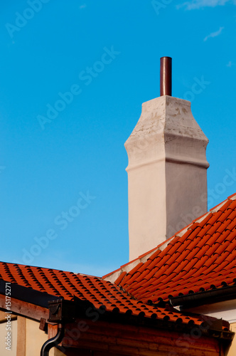 closeup of red roof and big rustical chimney