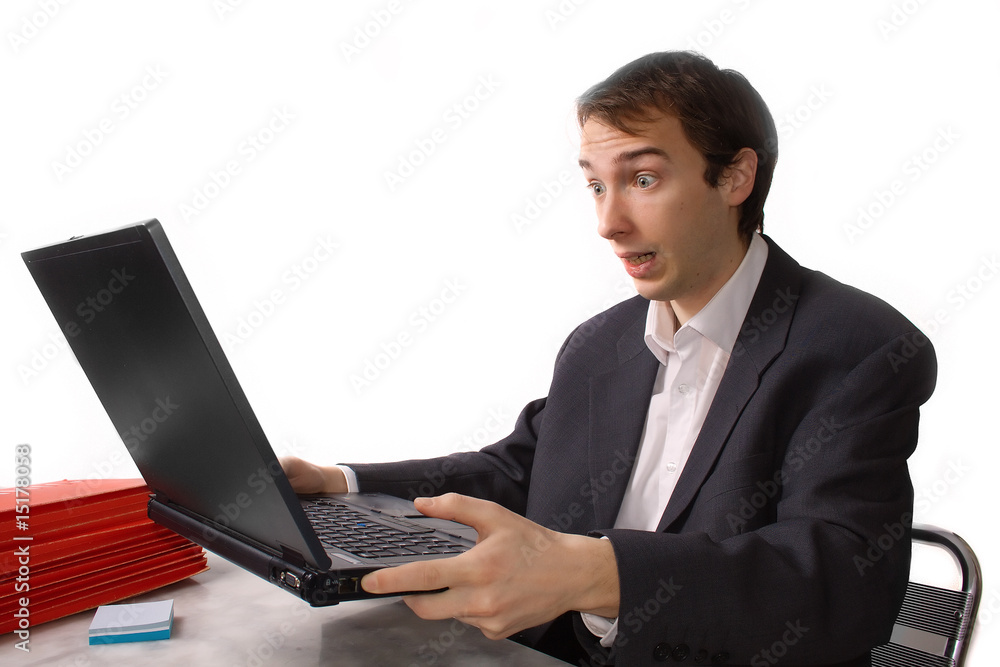 Young man freaks out in front of laptop Young man freaks out in front of laptop