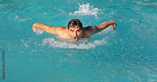Swimmer in a pool training butterfly stroke © FotoMak