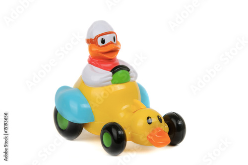 Toy duck driving duck-car on white background