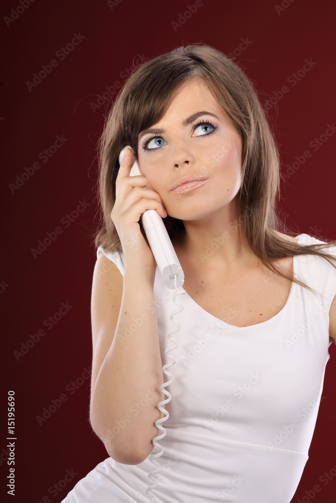 Fototapeta premium Woman on Phone . red background