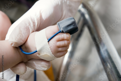 Hand of a  doctor with oximeter sensor