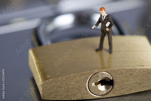 Business man on secure pedlock photo